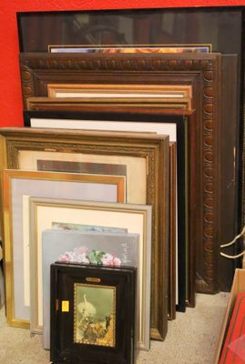 a lot of picture frames on the floor in this room