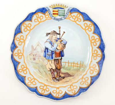 a plate with a picture of a man and a dog on it