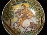 a bowl with a picture of a man riding a horse