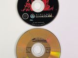 two cds that are sitting next to each other on a white surface