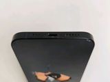 the back of a black cell phone with a pair of shoes on it