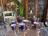 a glass table with cups and saucers on it
