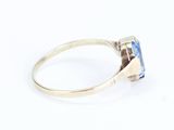 a close up of a ring with a tan sapphire stone in it