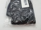 a black tie wrapped in plastic on a white table