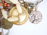many different types of necklaces on a white surface