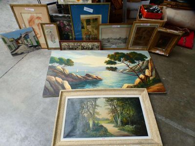 a lot of paintings and framed pictures on the floor