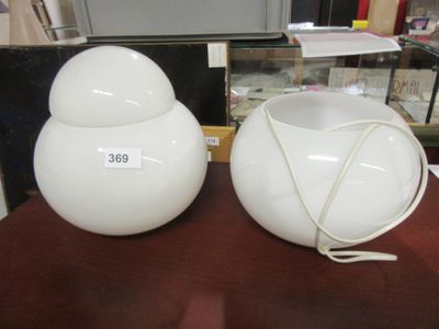 two white vases sitting on a table with a price tag on them