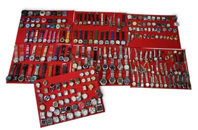 many different types of watches displayed in a red case