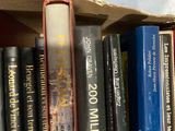 many books that are on a shelf in a box
