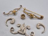 three gold and diamond brooches and a pair of earrings