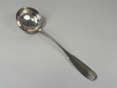 silver spoon on a white table with a silver handle