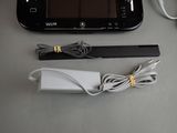 nintendo wii game console with charger and accessories sitting on a table
