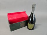 a bottle of wine next to a box with a red box