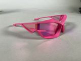 pink sunglasses on a white surface with a pair of pink glasses