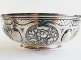 a silver bowl that is sitting on a table