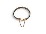 a close up of a bracelet on a white surface with a chain