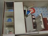 an overhead view of a miniature kitchen with a refrigerator, sink, stove, and dishwasher