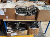 many boxes of items on a table in a warehouse