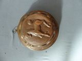 a metal object with a horse on it on a table