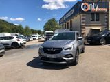 the car is parked in front of a building with a lot of cars parked in front of it