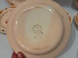 a person holding a plate with a drawing on it