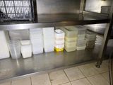 many containers of food on the shelf in the kitchen