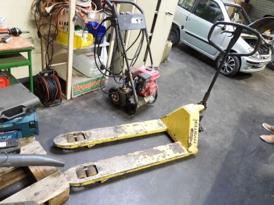two pallets that are sitting on the floor in a garage