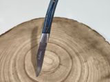 a knife that is on top of a piece of wood