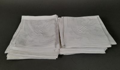 several folded white towels on a table with a cross on them