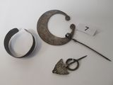 a pair of scissors and a pair of scissors next to a piece of metal