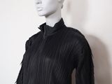 black pleaed top with fringes on a mannequin mannequin mannequin mannequin mannequin mannequin mannequin manne