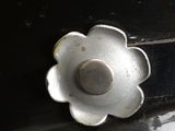 a close up of a metal knob on a black car