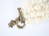 a necklace that has a bird charm on it