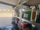 a shelf full of cleaning supplies in the back of a truck