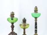 three green glass lamps sitting next to each other on a white surface