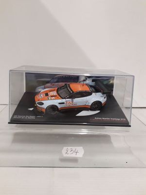 a white and orange car in a clear display case