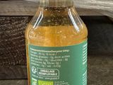 a bottle of liquid that is sitting on the ground