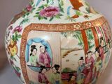 a vase that has a picture of people on it