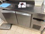 stainless steel counter top in a commercial kitchen with a dishwasher and dishwasher