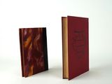two books sitting side by side on a white surface