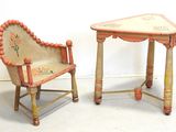 two chairs and a table that are sitting next to each other