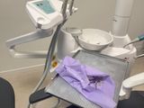a dentist chair with a purple cloth on it
