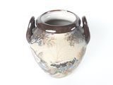 a vase with a painting on it sitting on a white surface