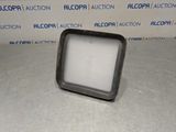 a close up of a square object on a table in front of a wall