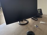 an image of a desk with a computer monitor, mouse, and other items
