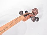 a close up of a violin that is on a white surface