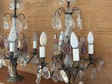 three chandeliers that are on a shelf in front of a wall