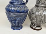 two vases sitting next to each other on a table