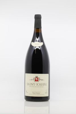 bottle of red wine sitting on a white surface with a white background