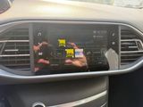 someone is taking a picture of a car ' s dashboard with their cell phone